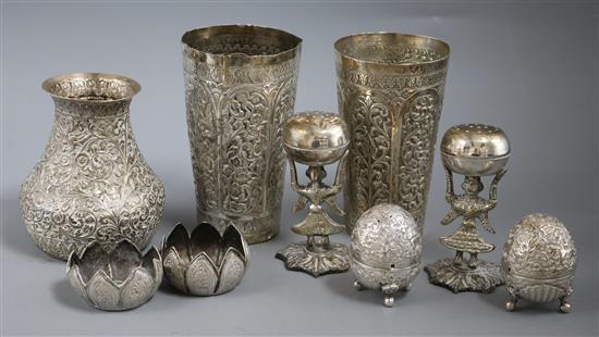 Two Indian white metal embossed beaker vases, six Indian condiments and one other Indian vase.